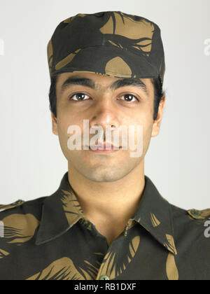 PORTRAIT OF INDIAN SOLDIER DRESSED IN UNIFORM FLASHING A VICTORY SIGN ...