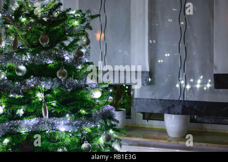 Decorated fir-tree at the window Stock Photo