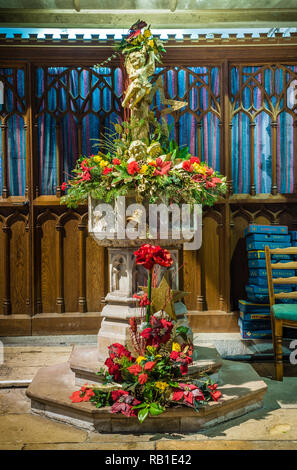 Christmas flower display at All Saints Church in East Budleigh. Stock Photo