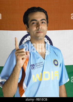 PORTRAIT OF A CRICKET PLAYER  WITH THE INDIAN NATIONAL FLAG IN THE BACKGROUND Stock Photo