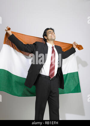 PORTRAIT OF A CORPORATE EXECUTIVE HOLDING THE INDIAN NATIONAL FLAG Stock Photo