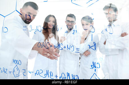 in the background image group laboratory scientists discussing their research Stock Photo