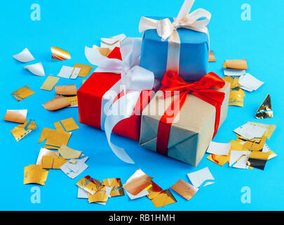 group of beautiful gifts Packed with ribbons and bows on blue background Stock Photo