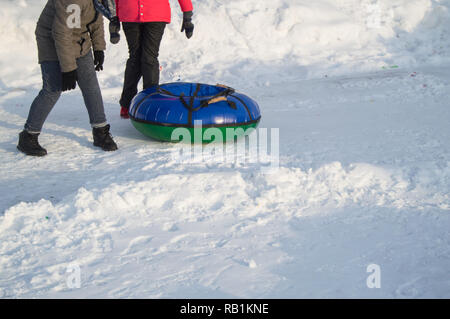 Two teenage girls rolled down the mountain on a tubing, winter fun in the Park. Stock Photo