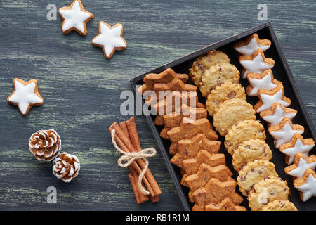 Christmas chocolate chip cookies, flat lay with spices and winter decorations on dark rustic wood Stock Photo