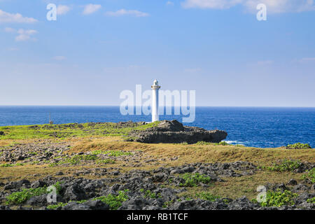 white lighthouse in cape zanpa in Japan with blue sea and sky Stock Photo