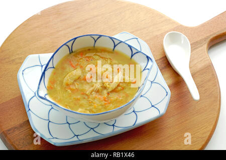 Home made chicken vegetable soup on bamboo pizza board shot from overhead in horizontal format Stock Photo