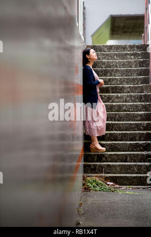 Asian female model poses for pictures on the street Stock Photo