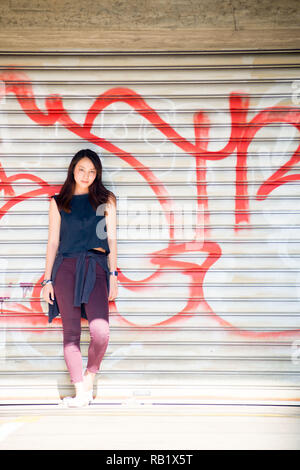 Asian female model poses for pictures on the street Stock Photo