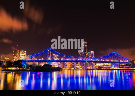 Story Bridge at Night low angle cityscape showing light reflections on the Brisbane River. Stock Photo