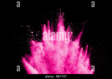 Pink powder explosion on black background. Pink dust splash cloud on dark background. Launched colorful particles on background. Stock Photo