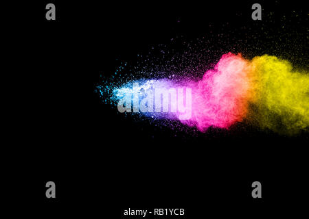 Color powder explosion cloud on black background. Freeze motion of color dust  particles splashing. Stock Photo