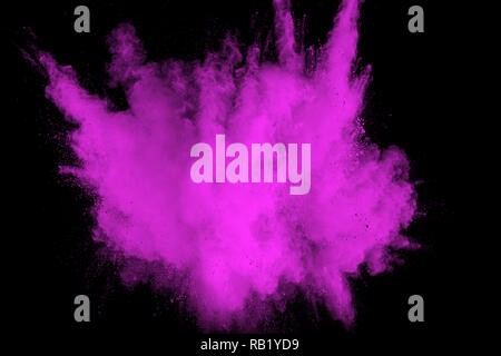 Pink powder explosion on black background. Pink dust splash cloud on dark background. Launched colorful particles on background. Stock Photo