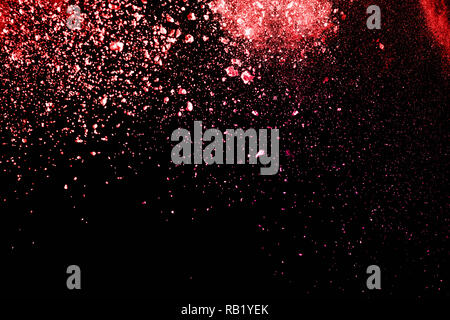 Pink dust particles splash on black background. Stock Photo