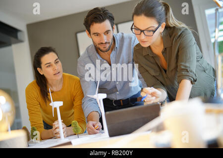 Attractive wind farm engineers looking over turbine placements Stock Photo