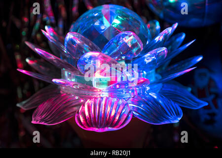 Rotating lamp in the form of a lotus, which shines in three colors. The original lamp design is an indispensable attribute that gives a special atmosp Stock Photo