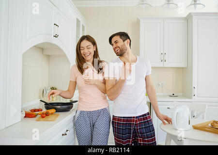 Young couple preparing food in the kitchen. Stock Photo