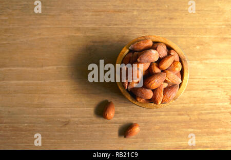 Almonds in wood bowl on the table Stock Photo