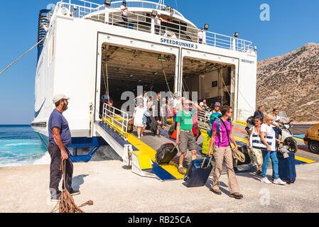 SIFNOS, GREECE - September 10, 2018: Tourists disembark from ferry ship in Sifnos island. Cyclades Stock Photo