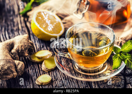 Ginger tea honey lemon and mint leaves on wooden table. Stock Photo