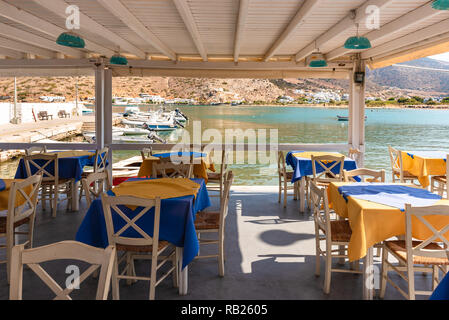 SIFNOS, GREECE - September 10, 2018: Tables with chairs on coastal promenade. Sifnos island, Greece Stock Photo