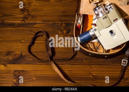 Vintage Super 8 cine camera from the 1960 Minolta Zoom 8 with his original case on wooden background Stock Photo