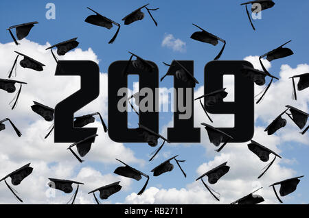 black graduation caps in summer sky with white clouds with year 2019 text Stock Photo