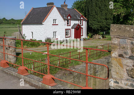 Whitewashed canal lockhouse UK. Moneypenny's Lock and Moneypenny's Lockhouse on the former Newry Canal in Northern Ireland. Stock Photo