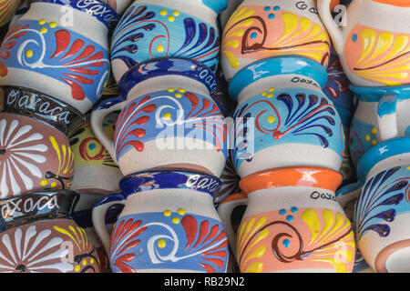 Isolated, close-up of colorful, decorative mugs that have Oaxaca written on them Stock Photo