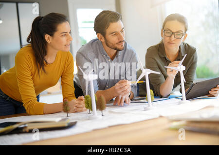 Attractive wind farm engineers looking over turbine placements Stock Photo