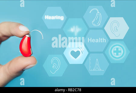 Doctor holding modern hearing aid with hearing icons flow on virtual screen.concept illustrates future technologies for the treatment of hearing Stock Photo