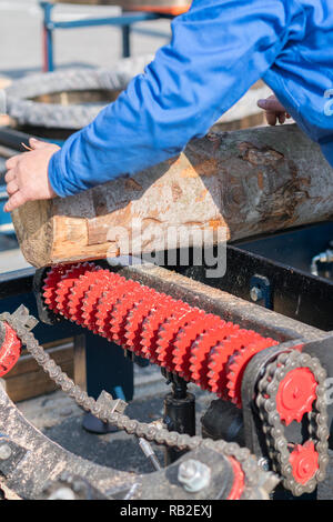 Worker works at a woodworking enterprise. wood industry. vertical photo. Stock Photo