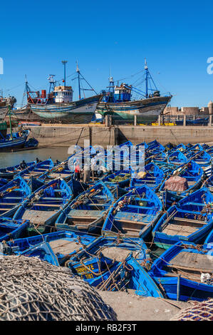 Blue painted Fishing boats moored in the harbour of the tourist destination of Essaouira on the Atlantic coast of Morocco Stock Photo
