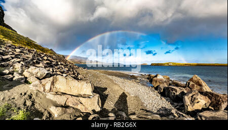 Rainbow above the famous Dinosaur bay at Staffin on the isle of Skye. Stock Photo