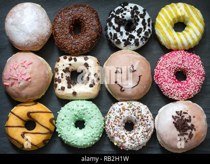 Doughnuts donuts various types of cakes abstract fat thursday concept Stock Photo