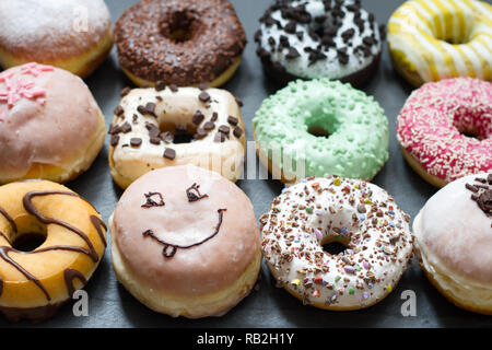 Doughnuts donuts various types of cakes abstract fat thursday concept Stock Photo