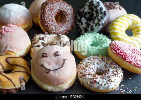 Doughnuts donuts various types of cakes abstract fat thursday concept Stock Photo