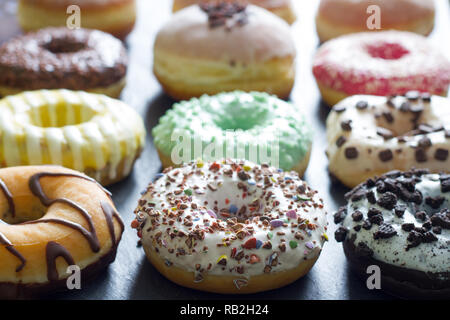 Doughnuts donuts various types of cakes abstract fat thursday concept Stock Photo