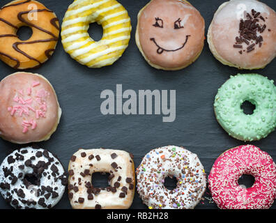 Doughnuts donuts various types of cakes abstract fat thursday frame concept Stock Photo