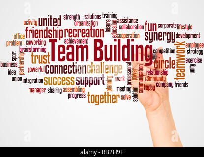 Team building word cloud and hand with marker concept on white background. Stock Photo