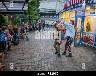 Berlin, Germany - May 20th 2018: Yound and old women dancing infront of a shop at Kreuzberg Carnival of Cultures Stock Photo
