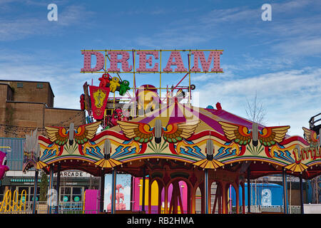 The word dream in pink letters above a carousel at margate dreamland Stock Photo