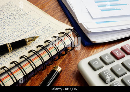 Small business accounting. Financial documents and pen on an office desk. Stock Photo