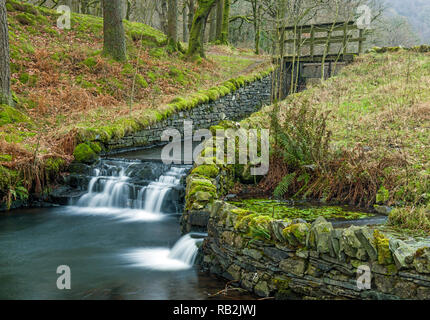 The outflow from Yew Tree Tarn in the Lake District National Park Cumbria Stock Photo