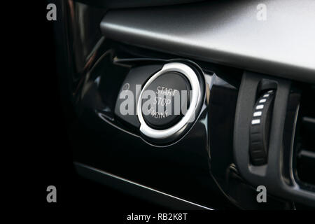 Car dashboard with focus on engine start stop button, car interior details Stock Photo
