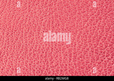 Genuine leather texture with embossed scales, pink red color of surface, trendy background, material for fashion accessories Stock Photo