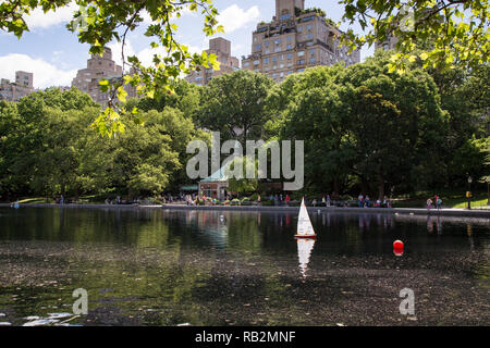 Model sailboat in the Conservatory Water in Central Park, New York. Stock Photo