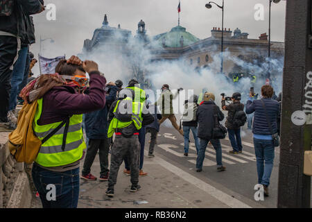 Thousands of protesters clashed with french authorities Saturday in Paris. that was the yellow vest movement's first action of 2019.  French President Emmanuel Macron is targeted for several weekends since october and is decision to raised fuel prices. Almost 50,000 people were protesting all over the country this Saturday. Stock Photo