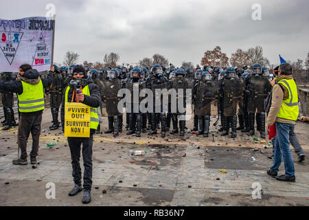 Thousands of protesters clashed with french authorities Saturday in Paris. that was the yellow vest movement's first action of 2019.  French President Emmanuel Macron is targeted for several weekends since october and is decision to raised fuel prices. Almost 50,000 people were protesting all over the country this Saturday. Stock Photo