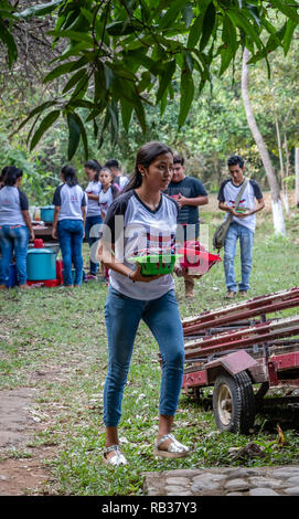 latin waitress serving food at party in Guatemala Stock Photo